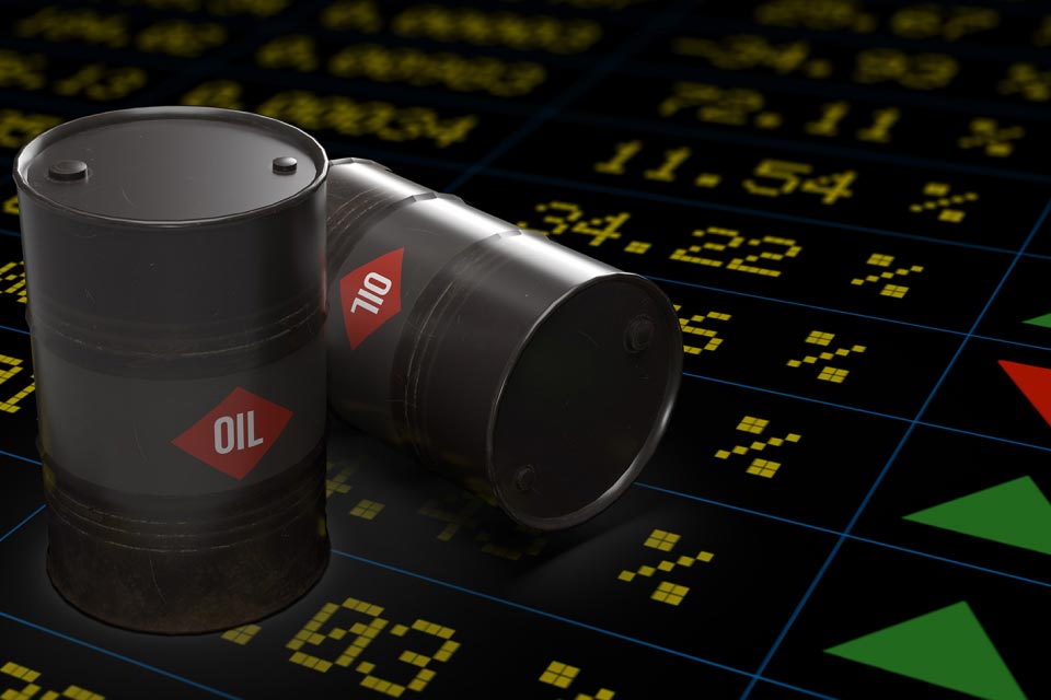 Barrels of oil placed on a digital stock market background, illustrating the impact of Fed rate cuts on oil prices.
