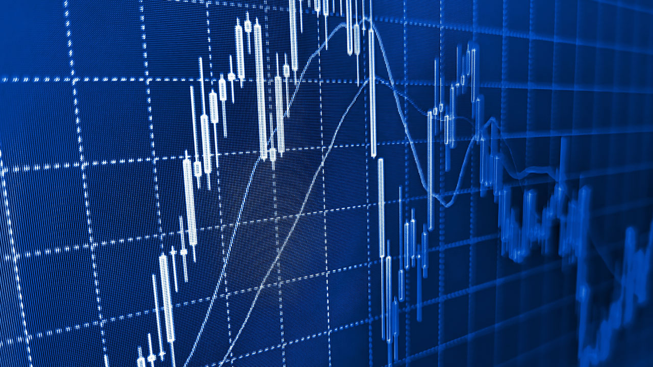 A digital stock market chart with blue candlestick patterns and line graphs representing price movements, illustrating the concept of high-frequency trading (HFT) and its rapid execution strategies.
