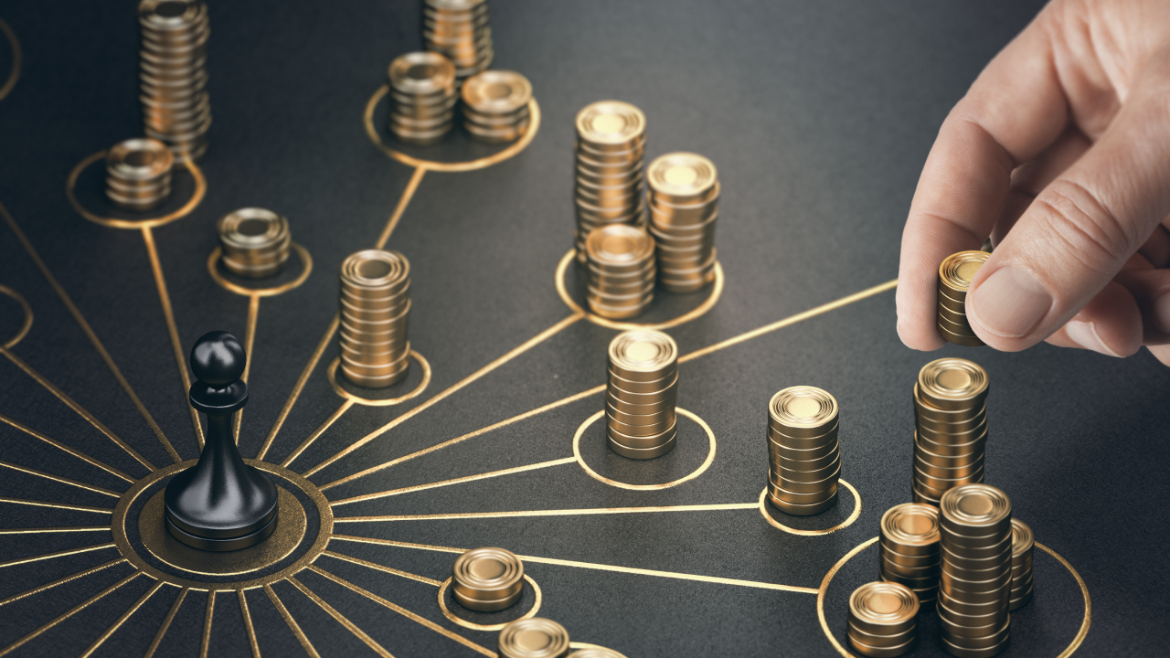 a hand places a stack of gold coins on a circular network diagram