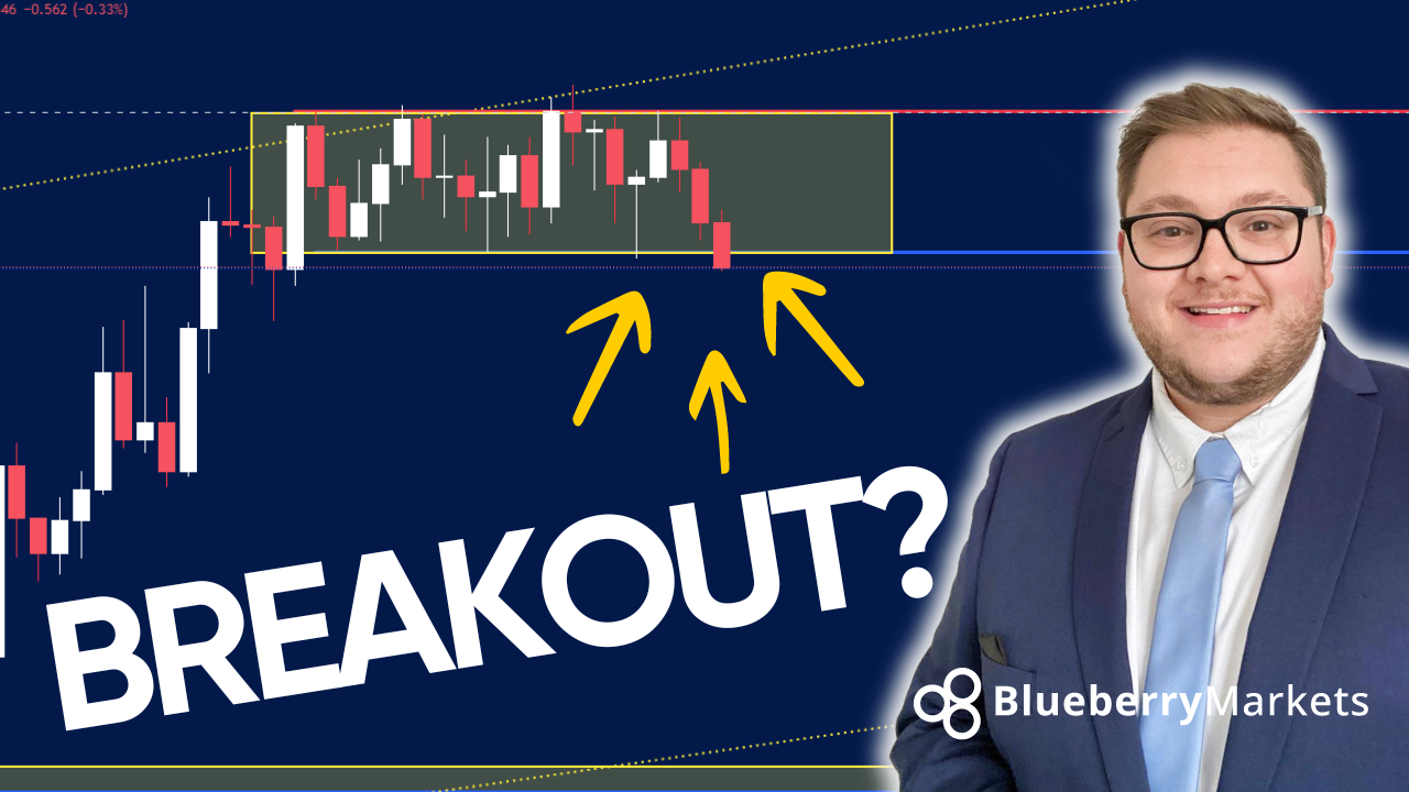 A man in a suit and tie standing beside a candlestick chart showing a breakout below a consolidation zone, highlighted by a yellow box and yellow arrows pointing down, illustrating traders spotting a forex breakout.