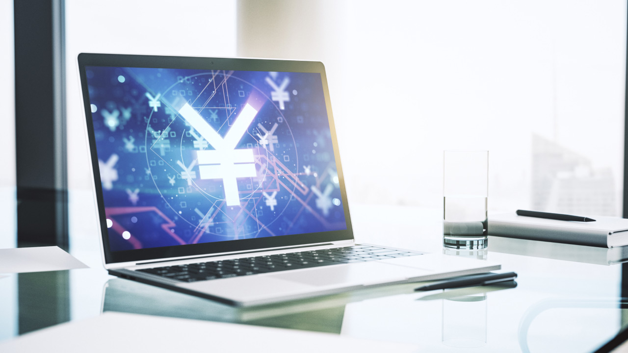 Laptop screen showing a glowing Japanese yen (¥) symbol among digital financial graphics, illustrating "How to Trade the Japanese Yen?"