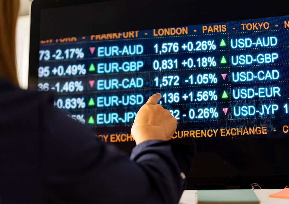 atrader analyzing forex exchange rates on a digital screen, focusing on EUR currency pairs