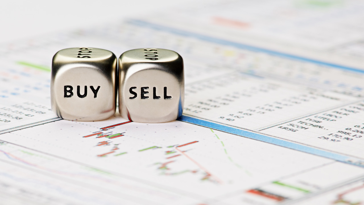 image of two metallic dice placed on a financial chart