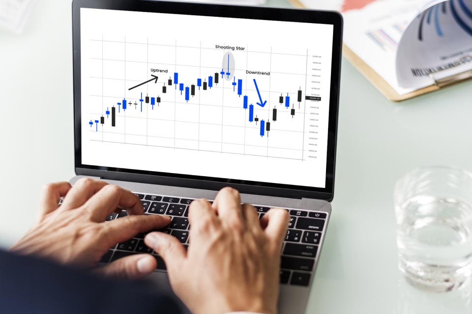  a trading chart on a laptop, showcasing a candlestick pattern with labels for 'Shooting Star'