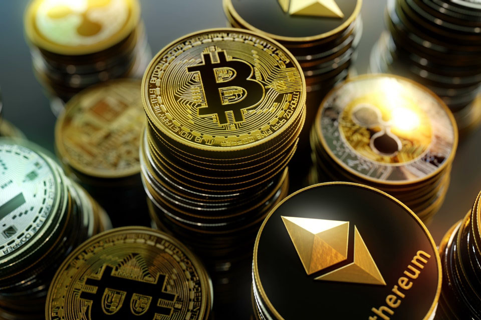 Top Cryptocurrency Forecasts for 2025, illustrated by stacks of Bitcoin, Ethereum, and Ripple coins.