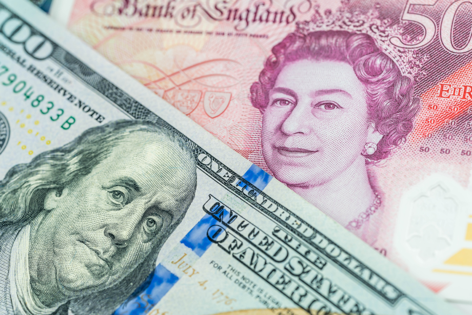 A £50 British Pound note (featuring Queen Elizabeth II) layered over a $100 US Dollar bill