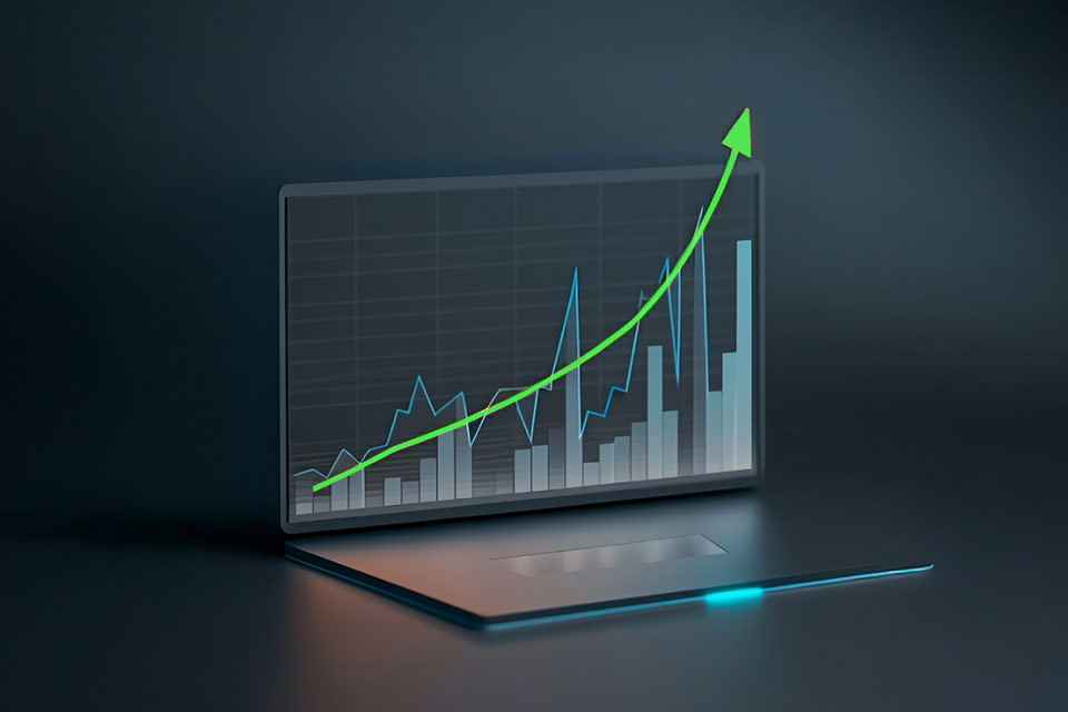 Can Positive Reevaluation Improve Your Trading Performance? an upward trending chart displayed on a laptop screen, illustrating growth and improved trading outcomes.