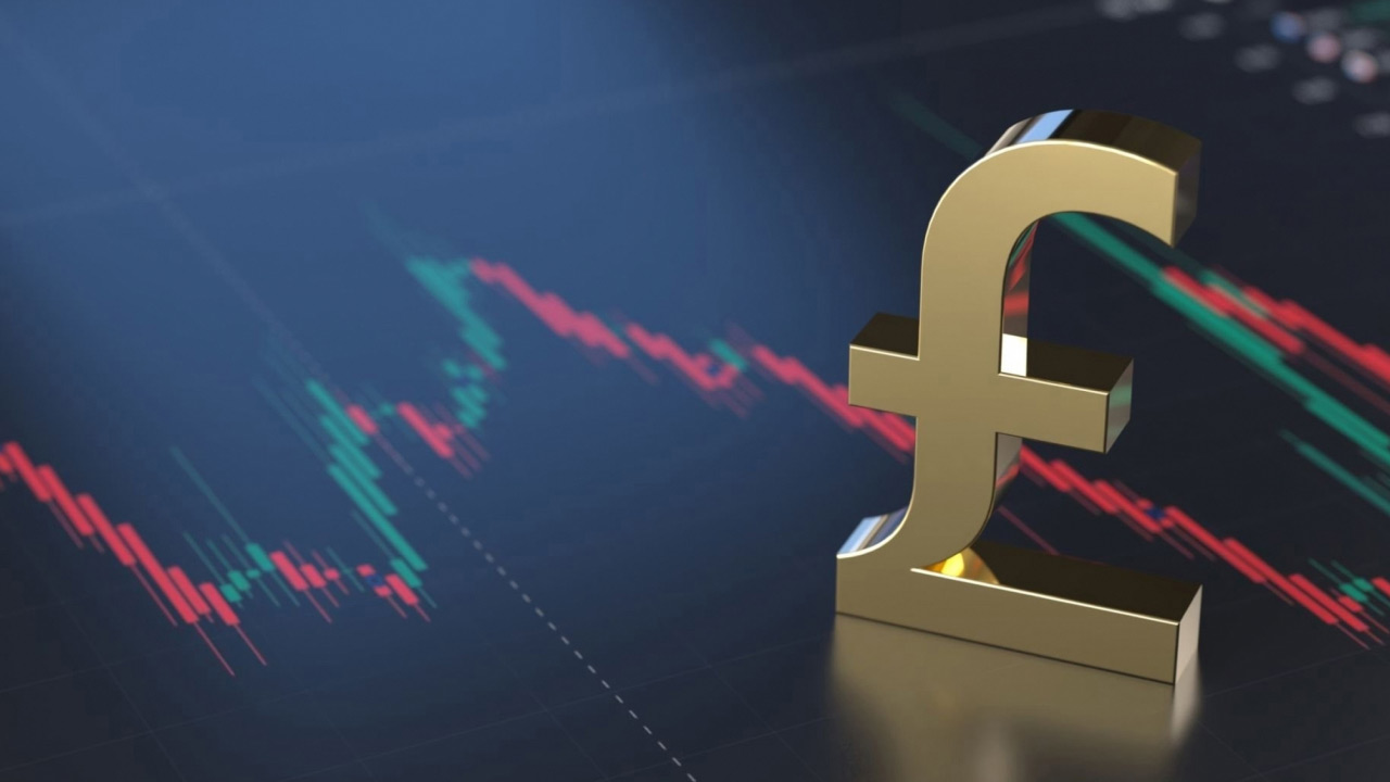 a large golden British pound (£) symbol stands in front of a digital chart 