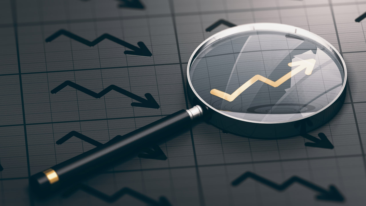 a magnifying glass is placed over a chart with a yellow arrow