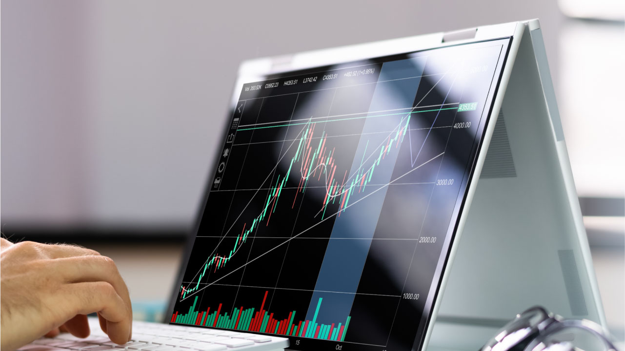  a convertible laptop in tent mode displaying a financial chart 