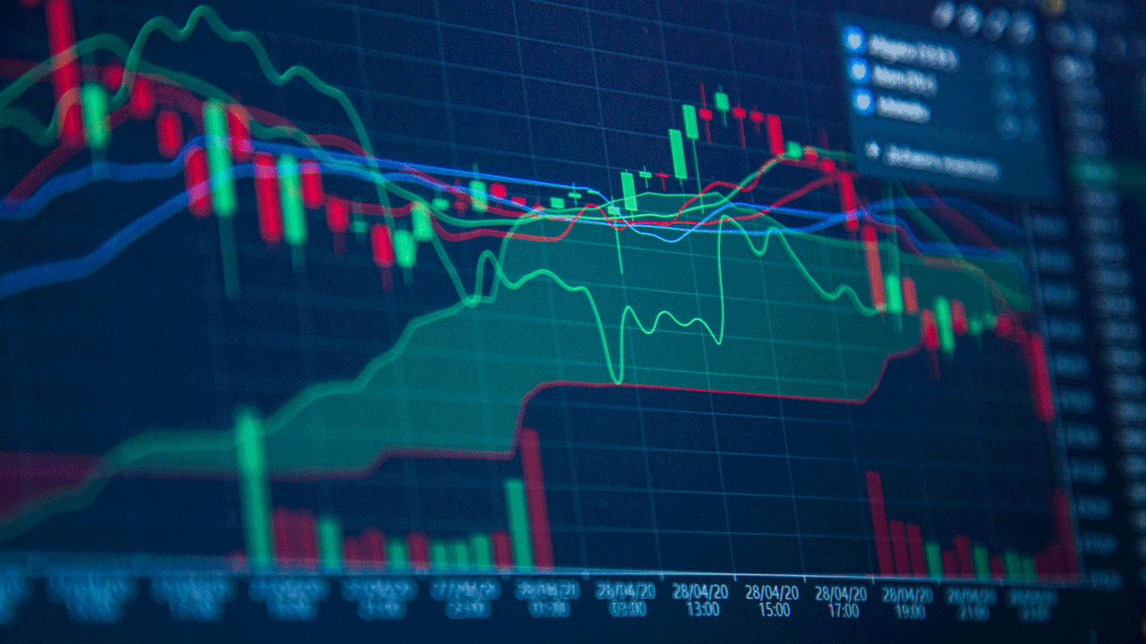 How to Open a Trading Account to Invest in the Tokyo Stock Exchange from Vietnam — close-up of a financial trading chart displayed on a dark screen showing red and green candlesticks.
