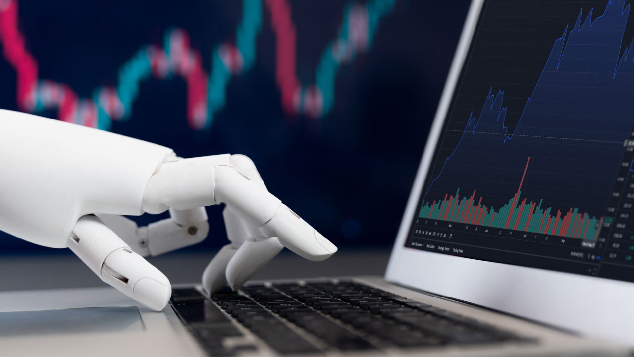 A robotic hand typing on a laptop keyboard with a stock market chart on the screen, symbolizing the integration of AI like ChatGPT in algorithmic trading.