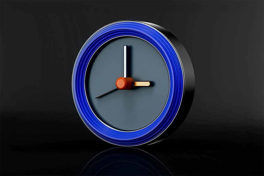 D-rendered clock with blue outer rim, orange center, and gold and white clock hands on a dark background