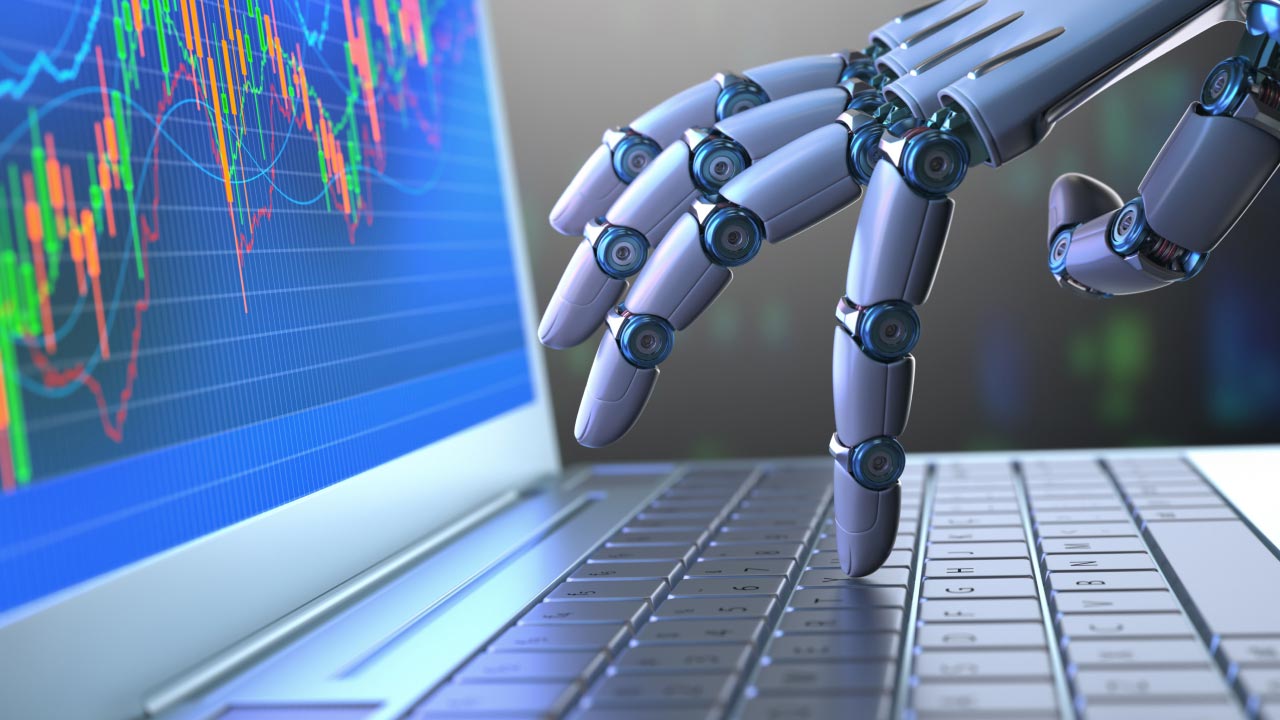 a robotic hand typing on a laptop keyboard with a financial trading screen