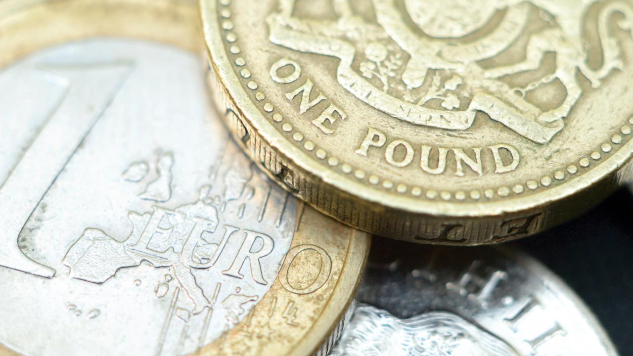 British Pound Reversal illustrated with a British one pound coin overlapping a one euro coin, representing a potential shift in GBP market direction.
